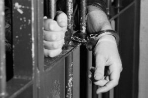 GERMANY - MAY 10: Symbolic photo to the topics: prison, justice, et, Our picture shows hands in handcuffs behind bars. (Photo by Ulrich Baumgarten via Getty Images)